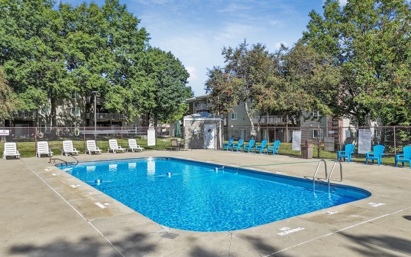 a swimming pool with chairs around it